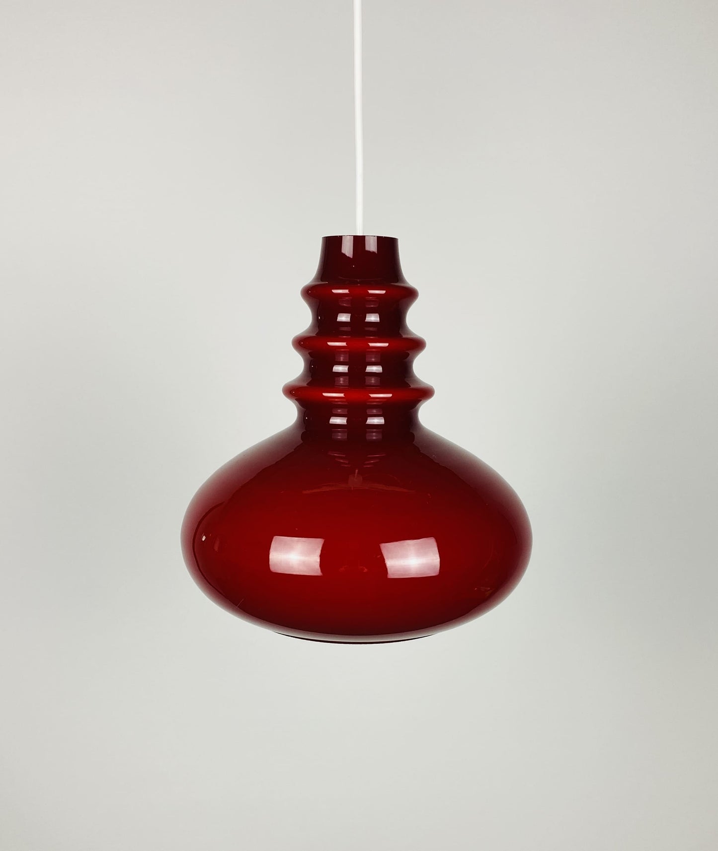 1 of 2 Dark red glass Peill & Putzler pendant light 1960