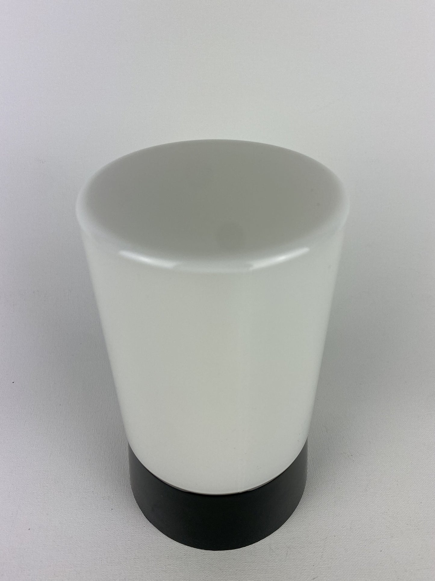 White cilinder shaped Art Deco RAAK ceiling light with black fixture