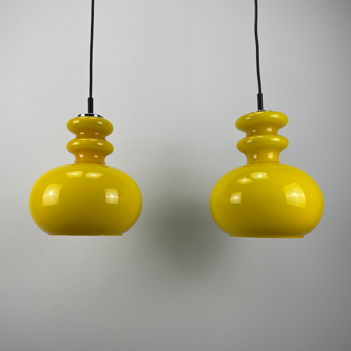 pair of yellow glass pendant lights
Peill & Putzler 1960s lighting
vintage mid-century modern pendants
retro yellow glass lamps for sale
German glass pendant lights