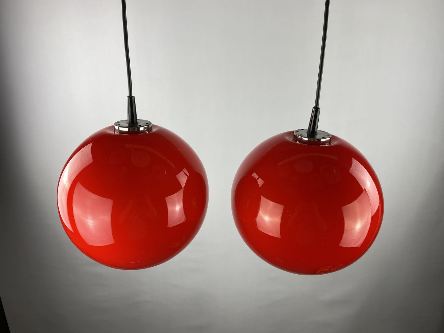Pair of two cherry red glass Peill & Putzler pendant lights