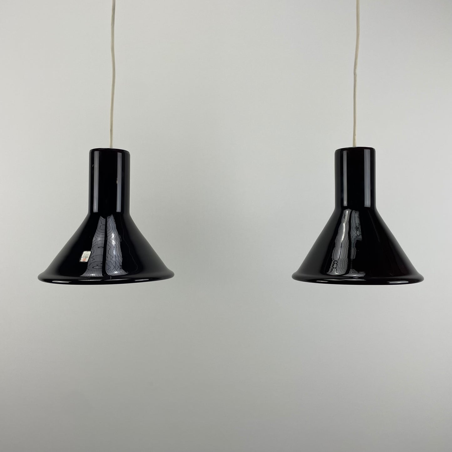 pair of aubergine glass P&T MINI pendant lights
Michael Bang for Holmegaard 1970s lighting
mid-century modern Scandinavian lighting
vintage purple glass pendant lights
Holmegaard pendant lamps for sale