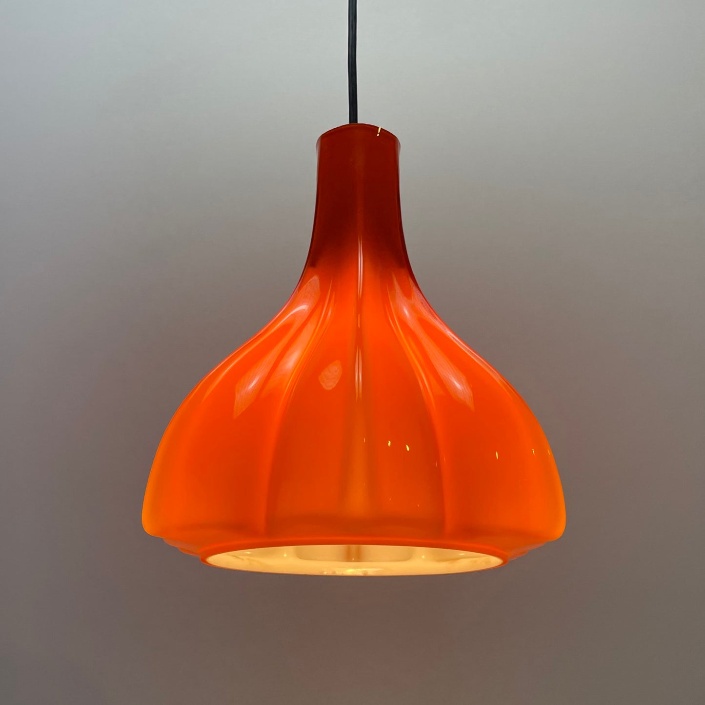 flower-shaped orange glass pendant light
Peill and Putzler 1960s design
mid-century modern floral lamp
vintage orange glass lighting
unique glass pendant light for sale