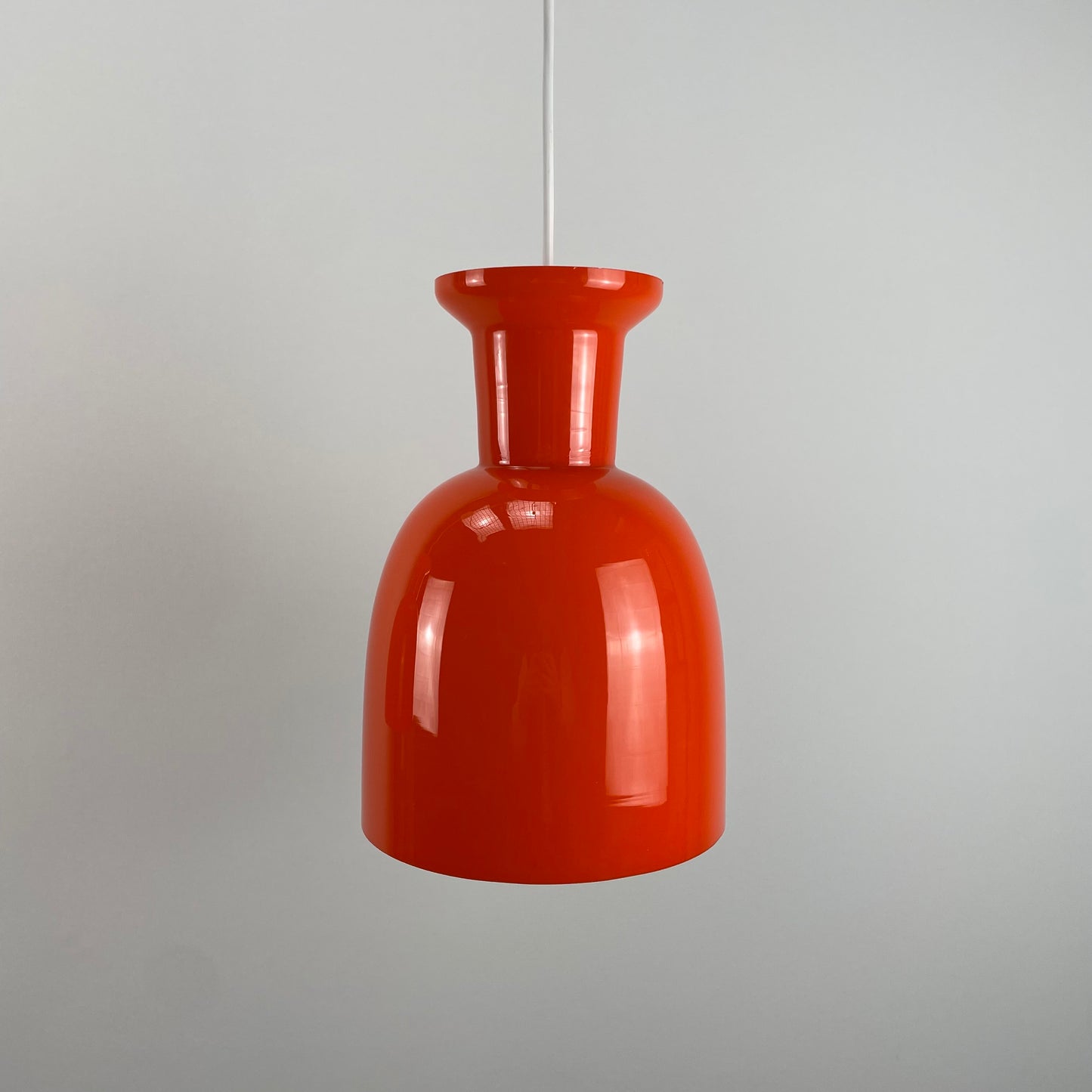 Pair of orange glass B-1203 pendant lights by Raak Amsterdam, 1970