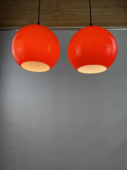 Pair of two cherry red glass Peill & Putzler pendant lights