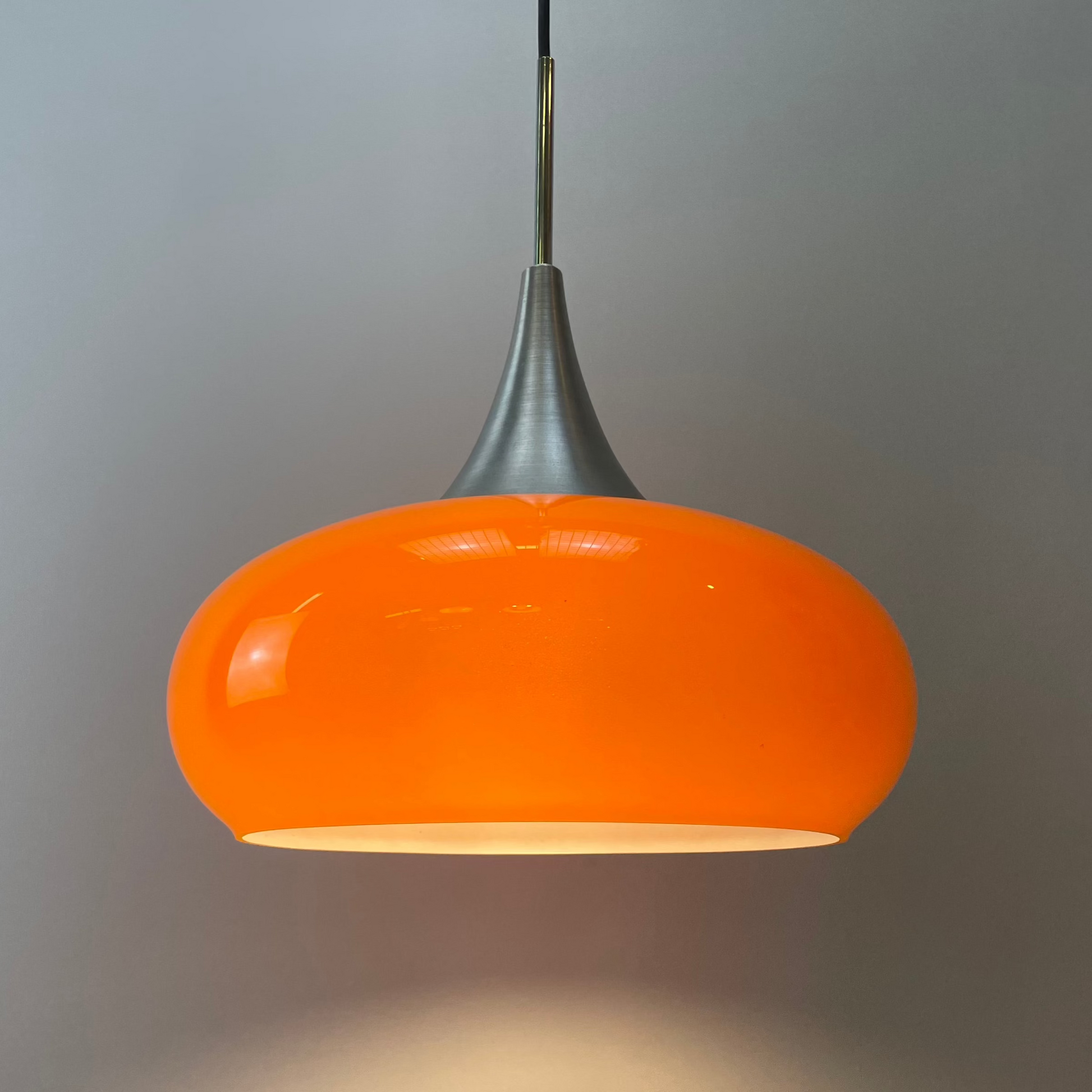 Doria Leuchten pendant light, orange UFO light, vintage glass lighting, 1970s pendant light, retro glass lamp, tulip-shaped light, unique ceiling light, mid-century modern design, aluminum pendant lamp, statement lighting.