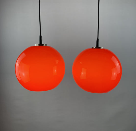 Pair of two cherry red glass Peill & Putzler pendant lights
