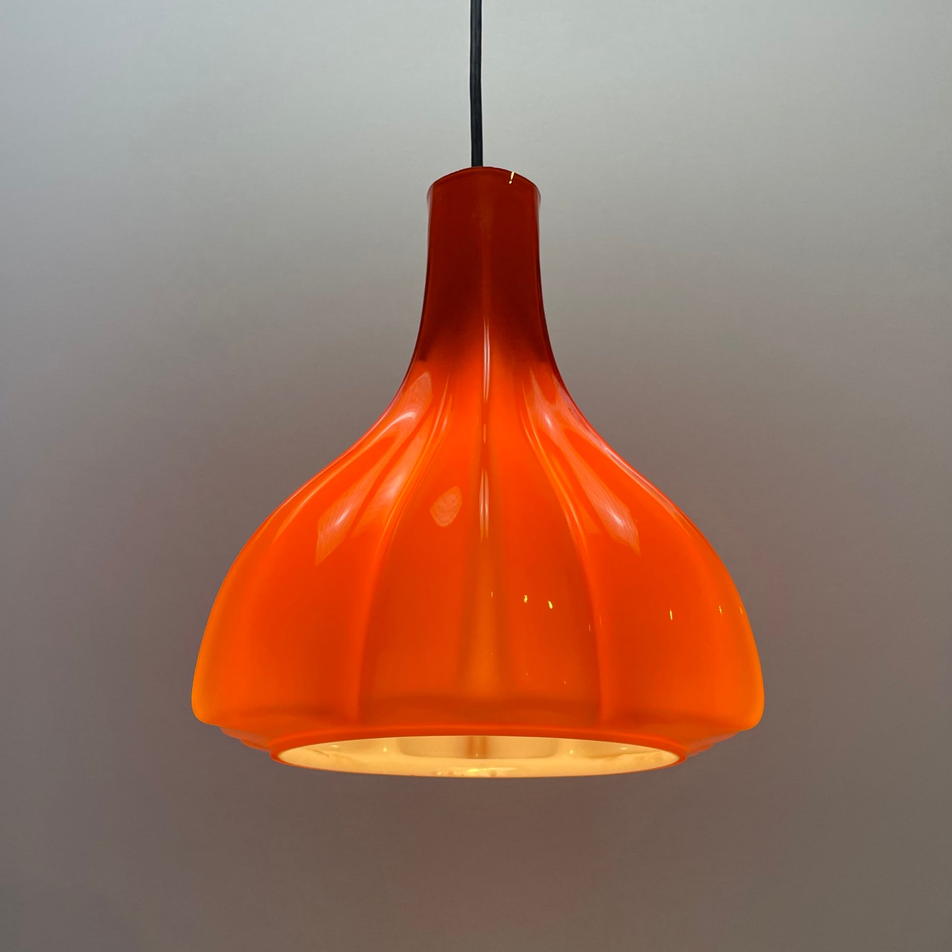 flower-shaped orange glass pendant light
Peill and Putzler 1960s design
mid-century modern floral lamp
vintage orange glass lighting
unique glass pendant light for sale